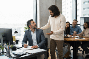 Man inviting tax professional to join colleagues at table