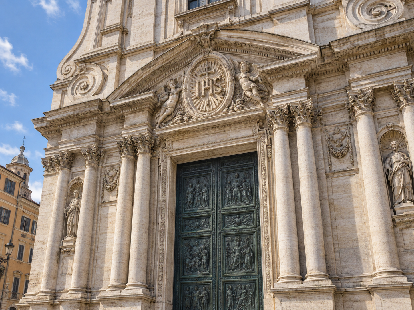 The Holy Name monogram above the central entrance of the Church of the Gesu
